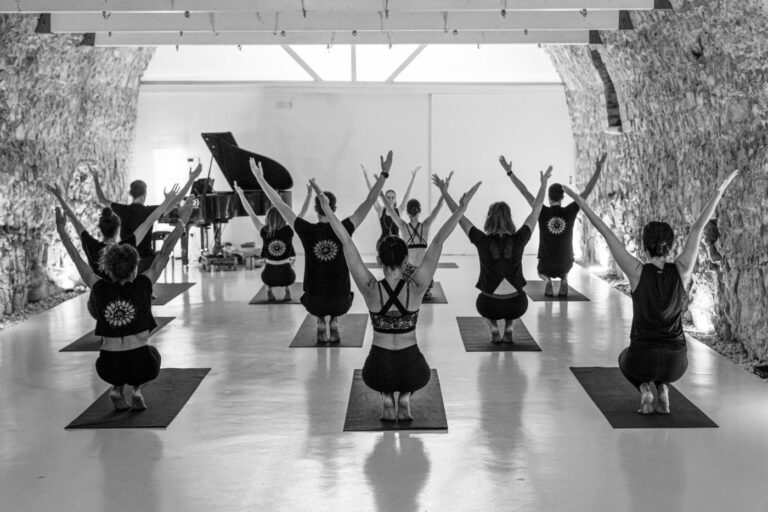 Classe di yoga con le braccia aperte nella sala grande